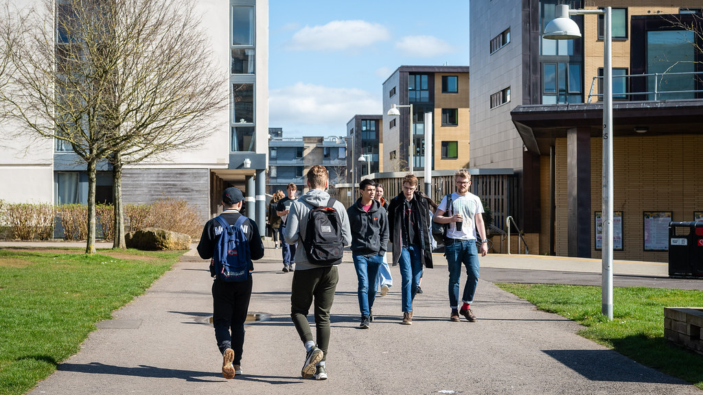 Students walking through the accommodation buildings on campus.