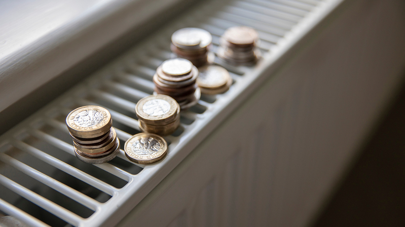 Coins balanced on a radiator