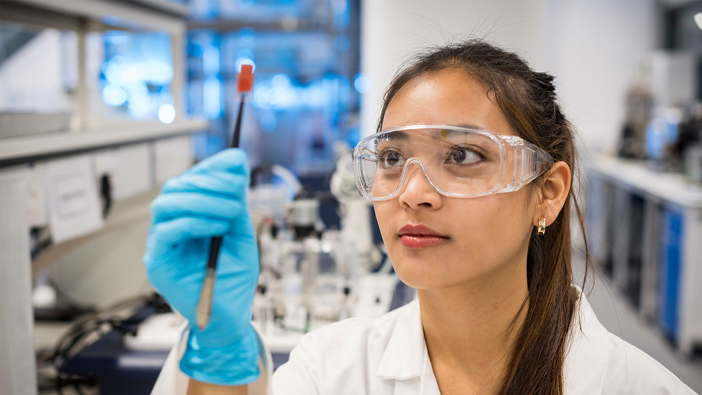 一个化学工程专业的学生在化学工程实验室检查她的项目.