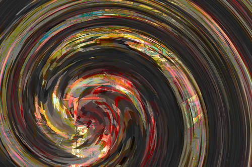 colorful abstract spiraling swirl against a dark background