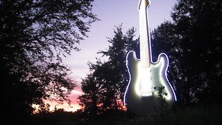 Rotating Neon Guitar At Sunset