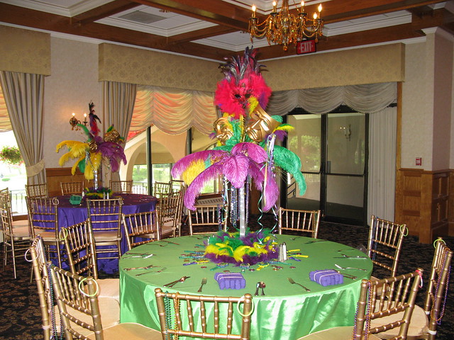 Mardi Gras themed centerpiece with comedy and tragedy masks, ostrich feathers and LED lights