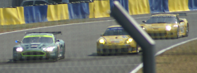 Aston Martin overtaking a Porsche