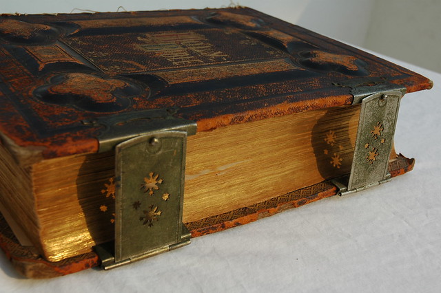 The Holy Bible, gold pages from the side, with metal clasps and embossed leather cover, dated 1885