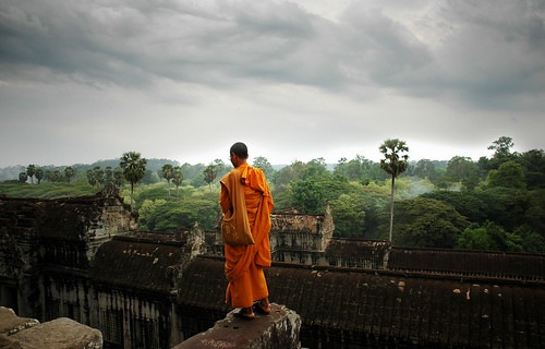 Angkor Wat Jungle Temple with praying monk by IanBrewer