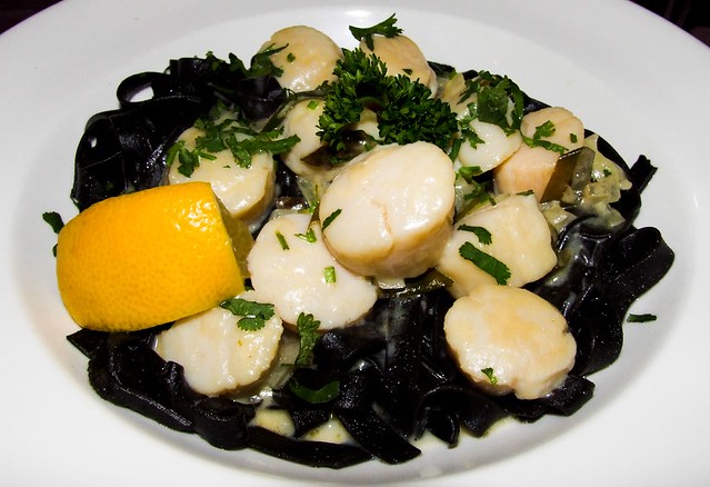 Scallops with lemon and garlic on squid-ink pasta