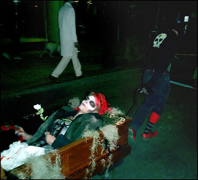 Emily in rolling casket pulled by Richie