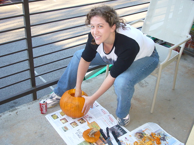 Alyssa hollowing out a pumpkin