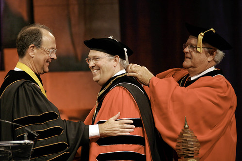 The Chancellor's Medatlion is placed around Chancellor Randy Woodson by Board of Trustees chair Lawrence Davenport while UNC System president Erskine Bowles looks on during the installation ceremony Tuesday at Reynolds. | by ncsuweb