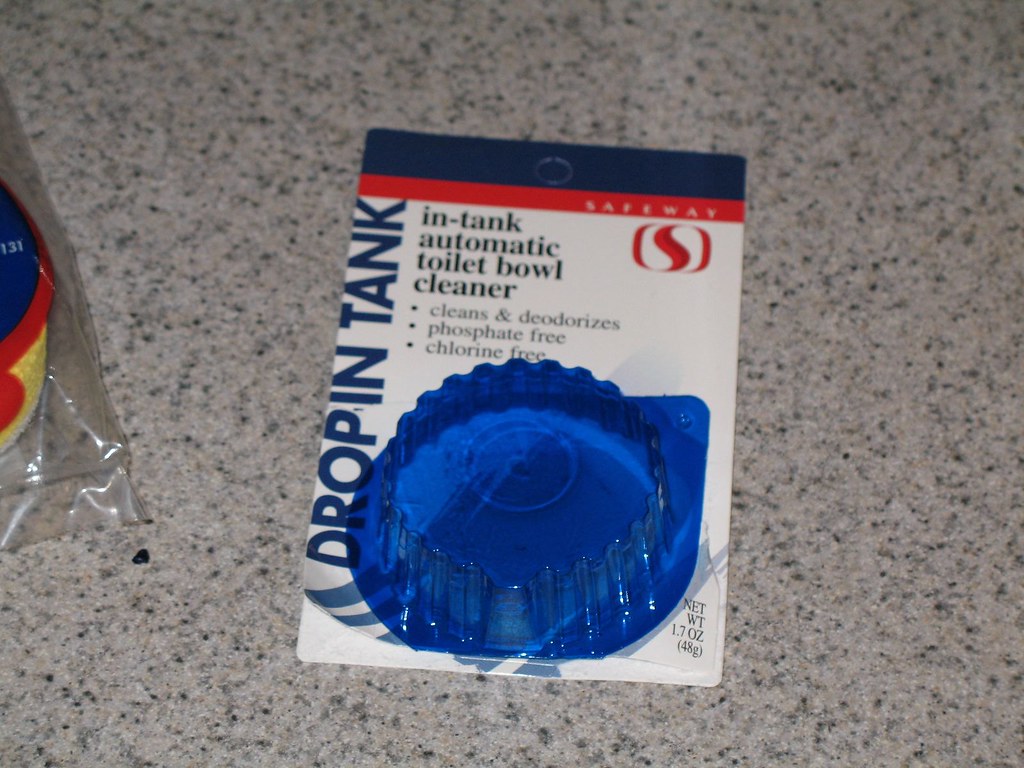 A bottle of Safeway In-Tank Automatic Toilet Bowl Cleaner.