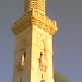 a minaret beside the green dome