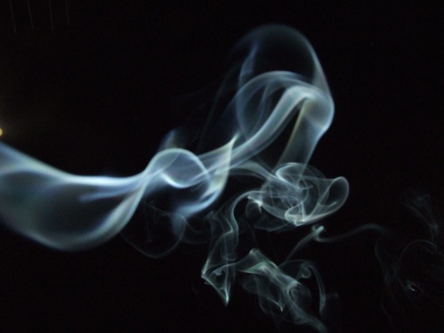 Incense smoke against a black sky