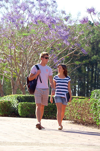 Two students walking at the entrance to Bond