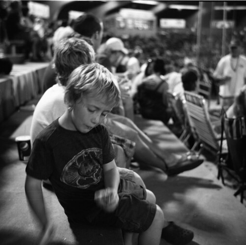boy in stands | by MalcolmYoung
