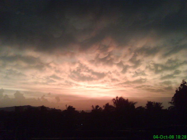 Monsoon clouds lit by sunset