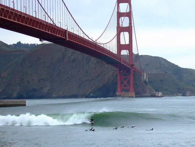 Surfers at Ft Point under Golden Gate Bridge