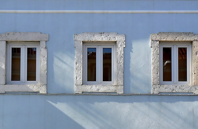 3 windows on a blue wall