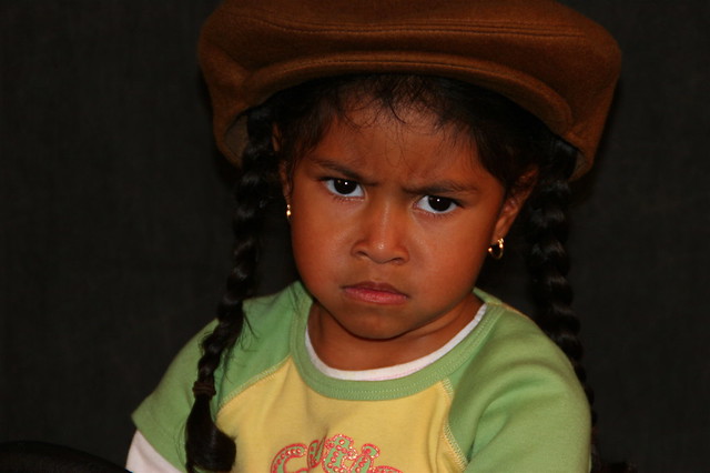 Girl Wearing Hat With Mean Look On Face