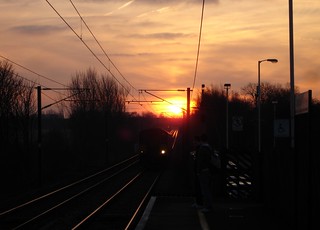 train arriving through sun