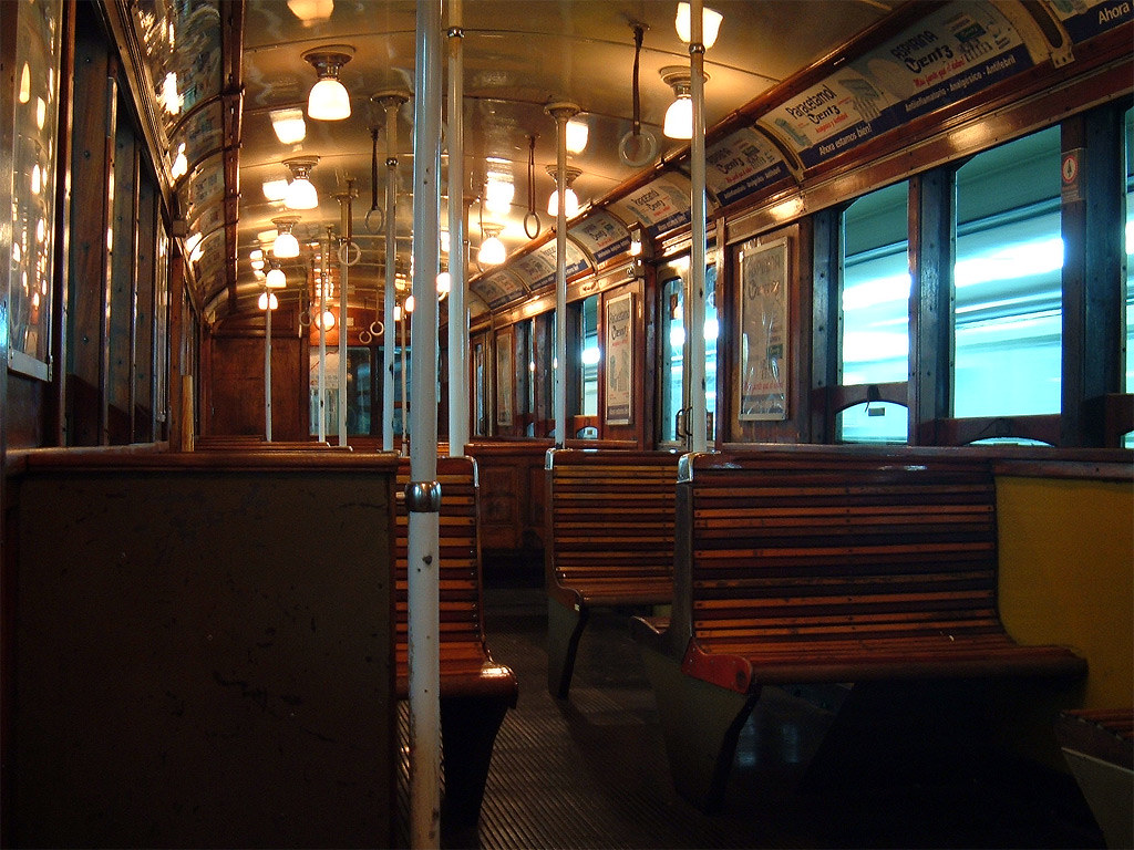 Wooden seating inside a historic underground railway carriage