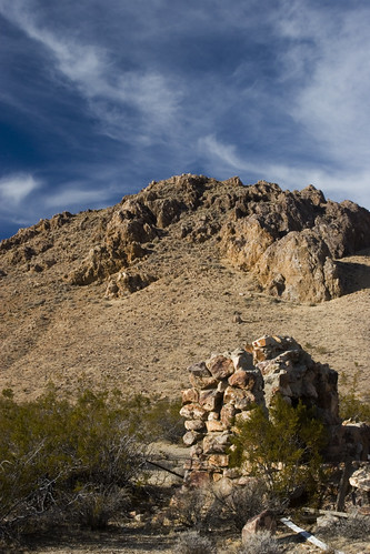 Ruins, Hill and Clouds by Jane Waterbury, Ruins of a small house close to an abandoned mine shaft. The location is close to Mojave, CA.canon20