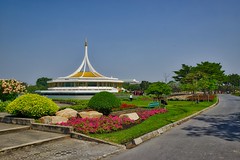 Rajamangala hall and flowers in Suan Luang Rama IX park in Bangkok, Thailand