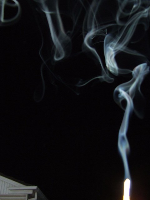 incense smoke against black background