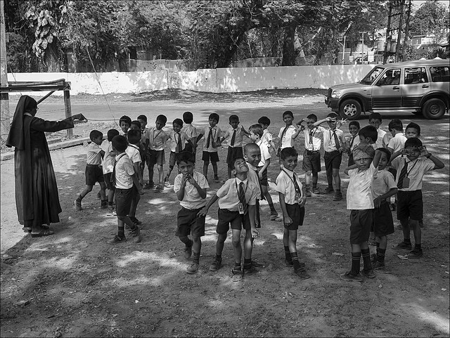 Peopla in India: School boys playing a game with their teacher