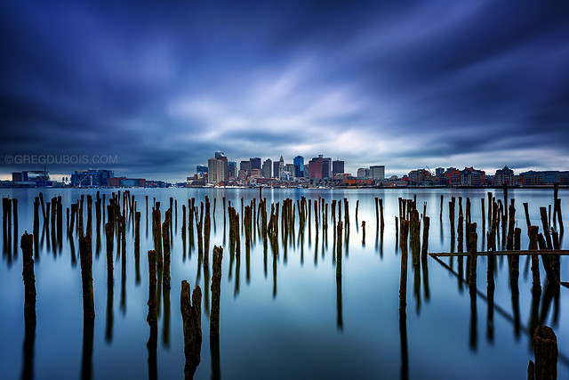 Lost Pier of Maverick Landing in East Boston with Decayed Pilings and Boston Skyline under Stormy Sky