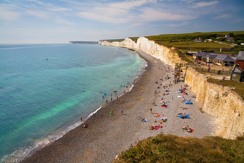 Bathers at Seven Sisters cliffs in East Sussex, UK.