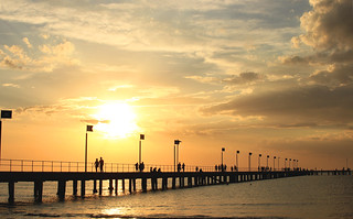 Pier, sunset, clouds and silhouettes