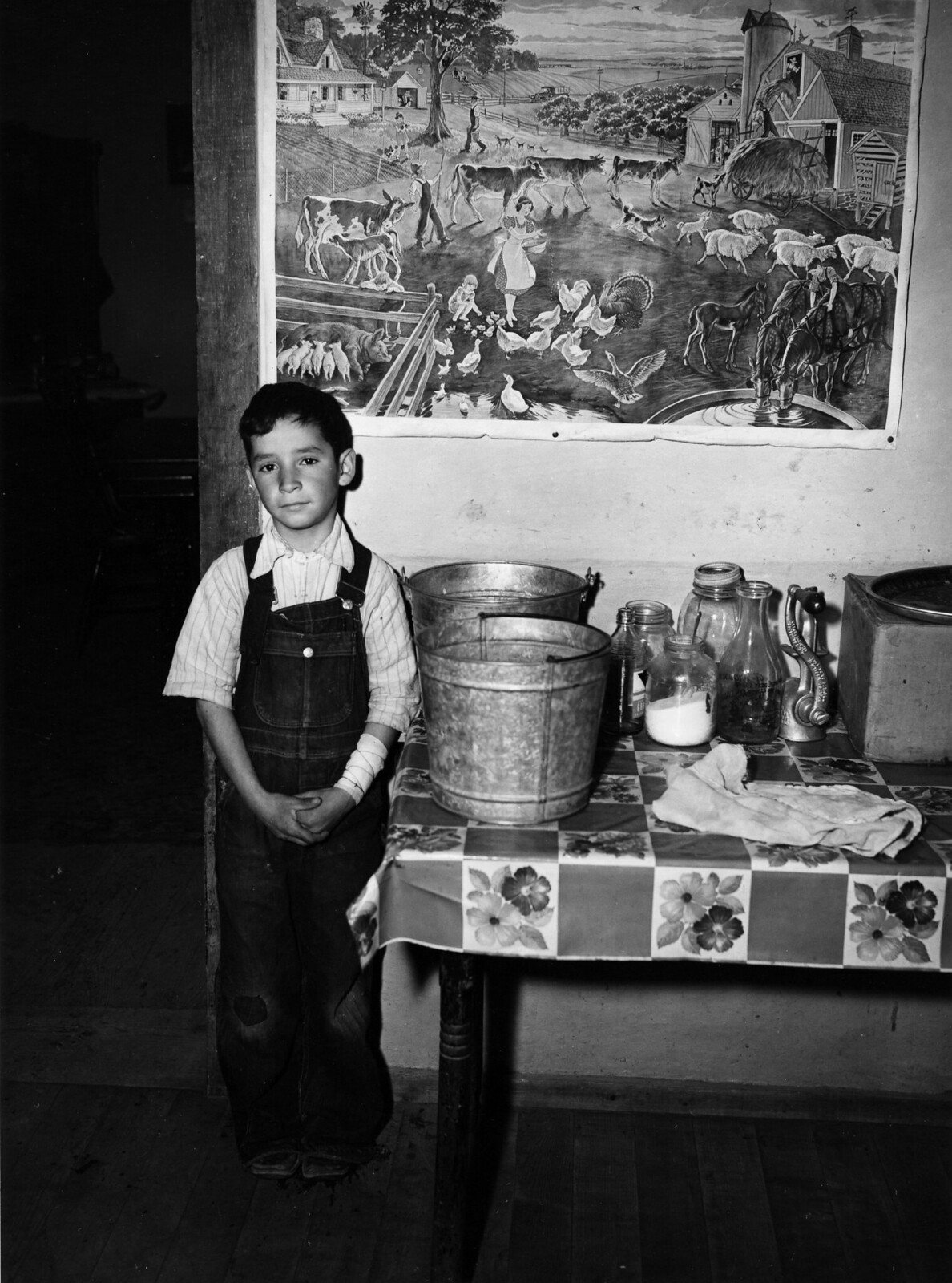 A boy standing in front of a picture