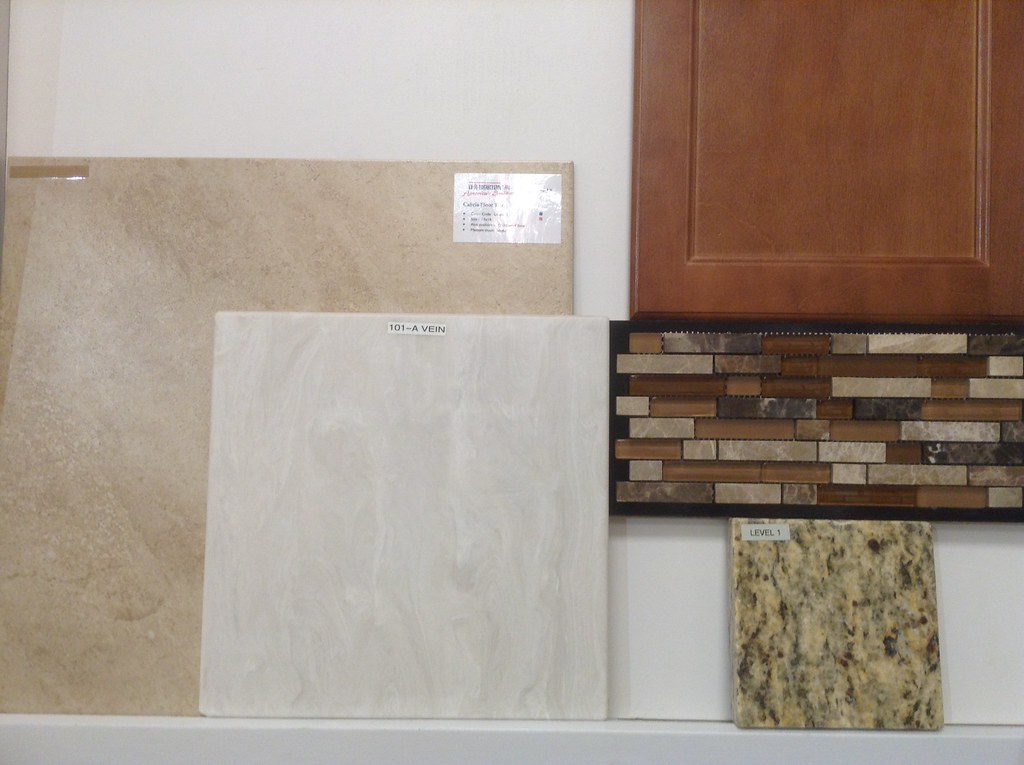 Tile, cultured marble(bathrooms), cabinet, backsplash & granite for the kitchen