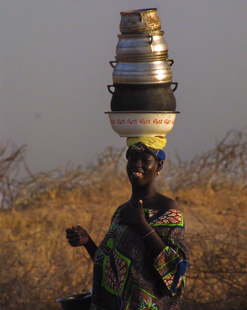 Gurunsi woman with pots on head