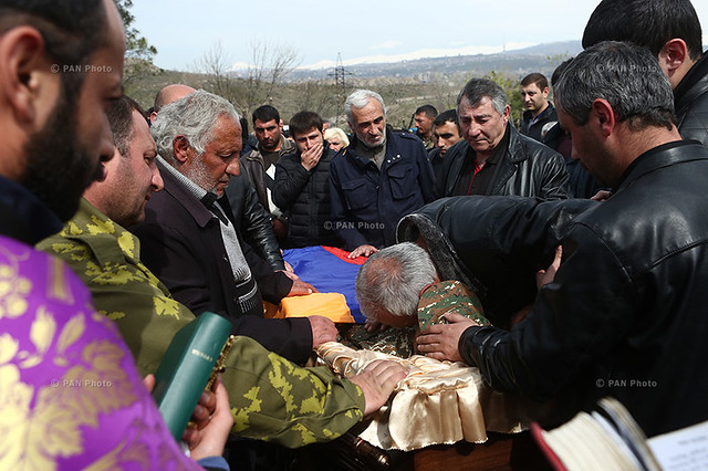 A man bids farewell to his son, contract serviceman Sasun Mkrtchyan, who was killed in the course of military operations on the line of contact between Nagorno Karabakh and Azerbaijan