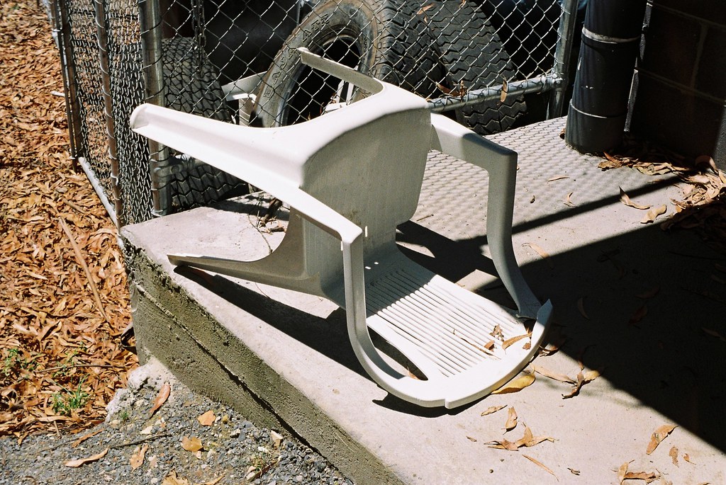 A knocked-over white chair