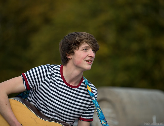 Young talented musician appearing in the autumn sun at 