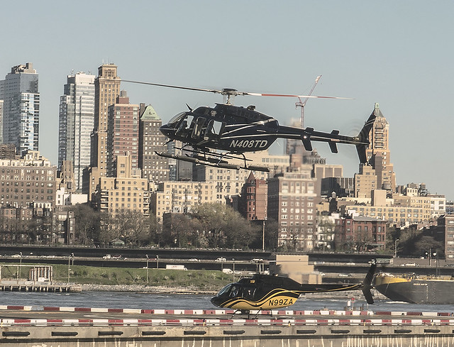 Helicopter Arriving and Departing Downtown Helipad In Manhattan With Brooklyn Heights In View