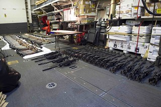 A cache of weapons is assembled on the deck of the USS Gravely. | by Official U.S. Navy Imagery