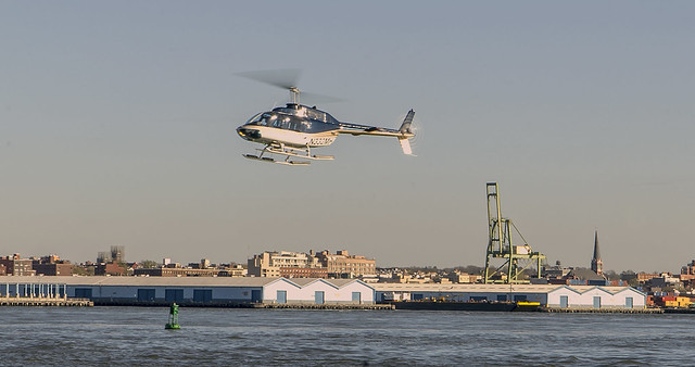 Helicopter Cruising Along East River NYC (Brooklyn Pier In View)