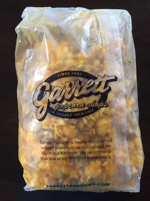 Family snacking on Garrett handcrafted popcorns from Chicago. A family business and recipe that has lasted since 1949 and attracted popcorn fans from around the world because of its enticing aroma without preservatives, and delicious taste!