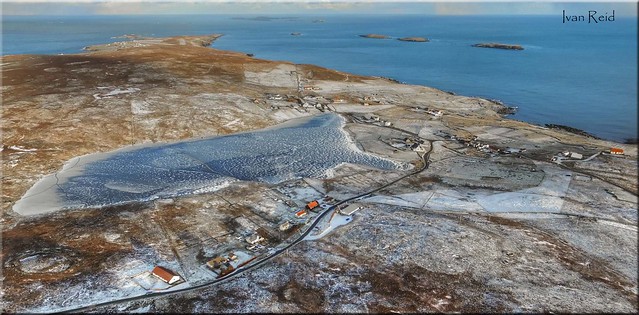Aerial view of Isbister, Whalsay on a frosty winter's day, the loch is totally iced over