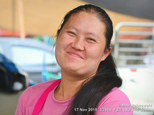 portrait smiling travel tourism market ethnic primelens woman female cultural character posing consent relationship emotion adult authentic pink closeup street tiltedhead eyes asia matthahnewaldphotography face facingtheworld chiangdao horizontal head nikond3100 outdoor thailand thai 50mm seveneighthsview expression northern headshot nikkorafs50mmf18g 4x3ratio 1200x900pixels resized lookingatcamera colour colourful person