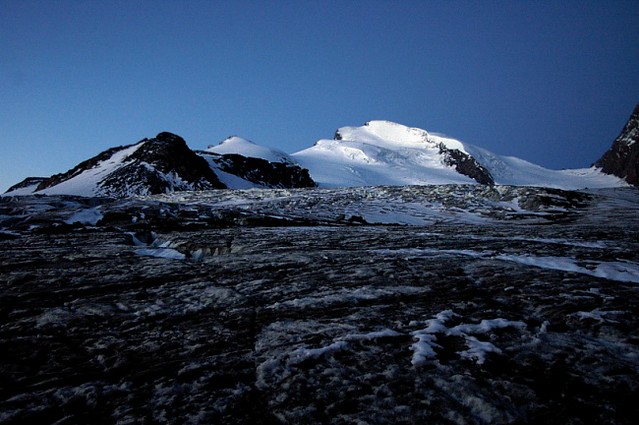 d0504034 | Unterwegs auf dem Allalingletscher, vor Sonnenaufgang. Frühes Morgenlicht leuchtet am Strahlhorn (4190 m) auf. Links davor das Fluchthorn (3790 m). Walliser Alpen, 01.09.2005