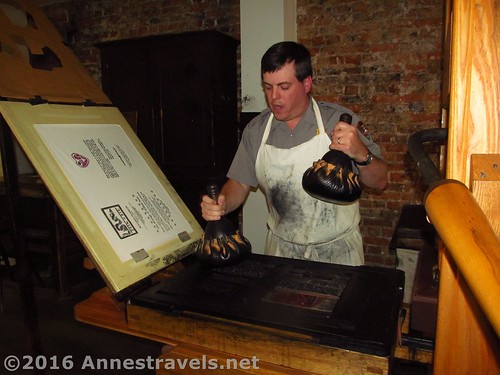 A craftsman demonstrating a printing press at Franklin Court, Philadelphia, Pennsylvania