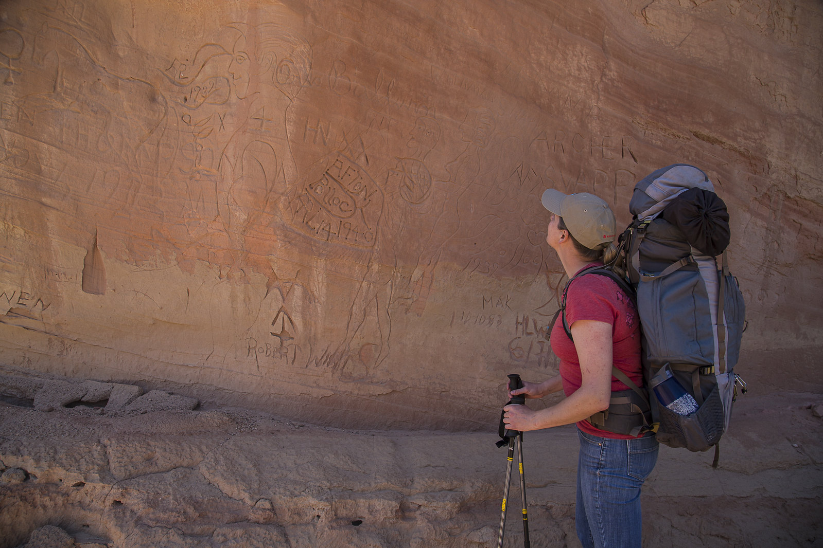A person looks at etchings at Vermilion Cliffs National Monument