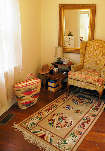 Reading Room, House renovation with mirror, armchair, Tibetan carpet and basket. Note rocking deer in mirror, Crown Hill, Seattle, Washington, USA