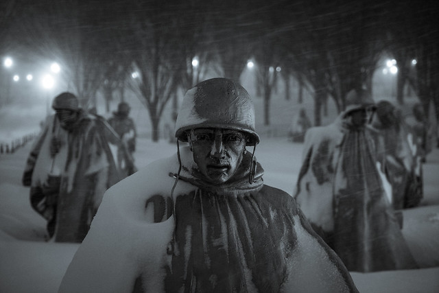 A soldier leads his men through the snow at the Korean War Memorial
