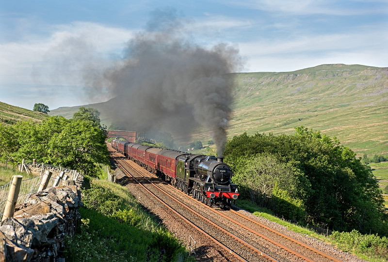 Jubilee 45690 'Leander' makes a spirited climb to Ais Gill with last nights returning Dalesman. The 3 cylinder roar could be heard long before and after she came into view powering her 12 coach load past Angerholme in lovely early evening sunshine. 