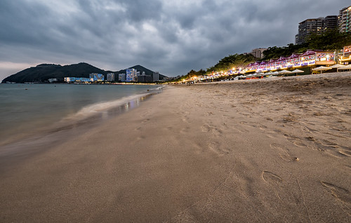 sanya china hainan beach water ocean sand sea shore landscape coast sky outdoor seashore outdoors travel cloud sandy seascape noperson cloudy sunset evening vacation lights dramatic relaxing wideangle tranquil tourism tourist